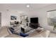 Open-concept living room features hardwood floors, modern decor and a fan at 8751 S 168Th Dr, Goodyear, AZ 85338