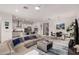 This open-concept area features hardwood floors, a large sectional couch and a chef's kitchen at 8751 S 168Th Dr, Goodyear, AZ 85338