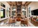 Comfortable lobby with fireplace and leather chairs below beamed ceilings and contemporary lighting at 8751 S 168Th Dr, Goodyear, AZ 85338