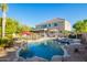 Spacious backyard features pool, rock waterfall, patio, lush landscaping, and exterior view of the house at 950 E Desert Inn Dr, Chandler, AZ 85249