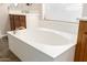 A close-up of the pristine soaking tub with sleek fixtures and bright natural light at 950 E Desert Inn Dr, Chandler, AZ 85249