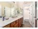 Spacious bathroom features double sinks, wooden cabinets, and a view of the shower and toilet room at 950 E Desert Inn Dr, Chandler, AZ 85249