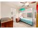 Bright bedroom featuring a bunk bed, ceiling fan, and natural light with a view to the ensuite bathroom at 950 E Desert Inn Dr, Chandler, AZ 85249
