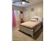 Bright bedroom featuring light-colored carpet, neutral walls, and feminine decor with a large bed and window at 950 E Desert Inn Dr, Chandler, AZ 85249