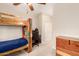 Bright bedroom features a wooden bunk bed with a ceiling fan, and is filled with natural light at 950 E Desert Inn Dr, Chandler, AZ 85249