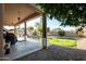 Relaxing covered patio with cozy lighting and view of landscaped backyard at 950 E Desert Inn Dr, Chandler, AZ 85249