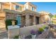 Close-up of a stone-accented entrance, adorned with potted plants and decorative details at 950 E Desert Inn Dr, Chandler, AZ 85249
