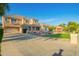 Inviting two-story home with a spacious driveway, manicured lawn, and mature trees at 950 E Desert Inn Dr, Chandler, AZ 85249