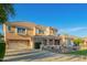 Well-kept two-story home featuring a neutral facade, lush lawn, and a wide driveway at 950 E Desert Inn Dr, Chandler, AZ 85249