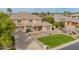 Imposing two-story home with tidy landscaping, stone details, and a tile roof at 950 E Desert Inn Dr, Chandler, AZ 85249