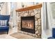 A stone fireplace with a wooden mantle and glass-fronted firebox creates an inviting ambiance at 950 E Desert Inn Dr, Chandler, AZ 85249