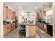 Spacious kitchen featuring a large island with seating, custom cabinetry, and modern appliances at 950 E Desert Inn Dr, Chandler, AZ 85249