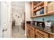 Bright kitchen with custom cabinetry and granite countertops, offering a glimpse into the living area at 950 E Desert Inn Dr, Chandler, AZ 85249