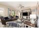 Inviting living room featuring a ceiling fan and a built-in entertainment center at 950 E Desert Inn Dr, Chandler, AZ 85249