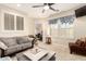 Inviting living room with plush sofa, plantation shutters, and neutral color palette, creating a relaxing atmosphere at 950 E Desert Inn Dr, Chandler, AZ 85249