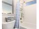 Bright bathroom with shower/tub combo and blue and white shower curtain at 950 E Desert Inn Dr, Chandler, AZ 85249