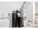 Bright utility room with water heater, water softener, storage bags, and additional room for storage at 950 E Desert Inn Dr, Chandler, AZ 85249