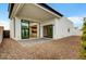 Spacious backyard featuring a paved patio, gravel accents, and large sliding glass doors to the interior at 100 W Northern Ave # 4, Phoenix, AZ 85021
