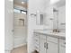 Well-lit bathroom featuring a vanity and tiled shower at 100 W Northern Ave # 4, Phoenix, AZ 85021