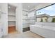Spa-like bathroom with soaking tub, shower, and natural light from large windows at 100 W Northern Ave # 4, Phoenix, AZ 85021