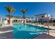 Stunning community pool with lounge chairs, palm trees, and modern cabanas at 100 W Northern Ave # 4, Phoenix, AZ 85021
