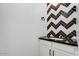 Chic half bath with stylish herringbone tile accent wall, sleek vanity, and modern fixtures at 100 W Northern Ave # 4, Phoenix, AZ 85021