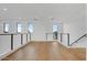 Second floor hallway with hardwood floors and large windows providing ample natural light at 100 W Northern Ave # 4, Phoenix, AZ 85021