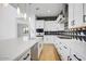Modern kitchen with white cabinets, a quartz countertop, and a stylish black-and-white backsplash at 100 W Northern Ave # 4, Phoenix, AZ 85021