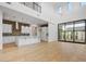 Bright living room with soaring ceilings and a modern kitchen featuring white cabinets at 100 W Northern Ave # 4, Phoenix, AZ 85021