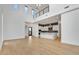 Bright living room with soaring ceilings and a modern kitchen featuring white cabinets at 100 W Northern Ave # 4, Phoenix, AZ 85021