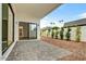 Inviting outdoor patio with stone pavers, sliding glass doors, and manicured landscaping at 100 W Northern Ave # 4, Phoenix, AZ 85021