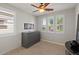 Bright bedroom with plantation shutters, a ceiling fan, and a cabinet in the wall for storage space at 1449 E Artemis Trl, Queen Creek, AZ 85140