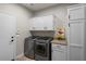 Well-equipped laundry room with modern washer and dryer, cabinetry, and countertop space for folding at 1449 E Artemis Trl, Queen Creek, AZ 85140
