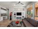Spacious living room with tile floors, neutral paint, large windows, and a entertainment center at 1449 E Artemis Trl, Queen Creek, AZ 85140