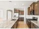 Kitchen with granite counters, a stainless-steel appliance package, tile backsplash, and modern faucet at 26949 W Lone Cactus Dr, Buckeye, AZ 85396
