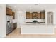 Spacious kitchen with granite countertops, modern stainless steel appliances, and updated cabinetry at 26949 W Lone Cactus Dr, Buckeye, AZ 85396