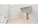 Utility room offering tiled floors and plenty of space for washer and dryer hookups at 26949 W Lone Cactus Dr, Buckeye, AZ 85396