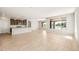 Open-concept living area with adjacent kitchen, recessed lighting, and backyard views at 26949 W Lone Cactus Dr, Buckeye, AZ 85396