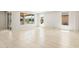 Spacious living room offering neutral tile flooring, recessed lighting, and scenic backyard views at 26949 W Lone Cactus Dr, Buckeye, AZ 85396