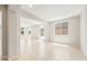 Expansive living area with arched doorways, neutral tile flooring, and recessed lighting at 26949 W Lone Cactus Dr, Buckeye, AZ 85396