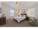 Well-lit bedroom with a queen bed, soft carpet, and large windows for natural light at 2929 E Sequoia Dr, Phoenix, AZ 85050