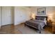 Simple bedroom featuring wood floors, a comfortable bed, and ample closet space at 2929 E Sequoia Dr, Phoenix, AZ 85050