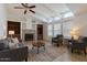 Bright living room with vaulted ceilings, a cozy fireplace, and built in bookshelves at 2929 E Sequoia Dr, Phoenix, AZ 85050