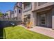 Charming outdoor patio with brick flooring, artificial grass, and comfortable seating at 300 N Gila Springs Blvd # 144, Chandler, AZ 85226