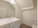Cozy powder room featuring a white vanity with sink, large mirror, and a toilet at 300 N Gila Springs Blvd # 144, Chandler, AZ 85226