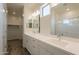 Bright bathroom features a double sink vanity and a glass-enclosed shower with brushed nickel fixtures and accessories at 300 N Gila Springs Blvd # 144, Chandler, AZ 85226