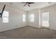 Bright bedroom with large windows, a ceiling fan, and a door leading to the exterior at 300 N Gila Springs Blvd # 144, Chandler, AZ 85226