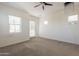 Bright bedroom featuring neutral carpet, white walls, access to the balcony through glass doors, and natural light at 300 N Gila Springs Blvd # 144, Chandler, AZ 85226