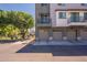 Modern townhome featuring gray paint scheme, individual garages, and tree-lined street at 300 N Gila Springs Blvd # 144, Chandler, AZ 85226