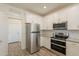 Modern kitchen with stainless steel appliances, white cabinets and subway tile backsplash at 300 N Gila Springs Blvd # 144, Chandler, AZ 85226